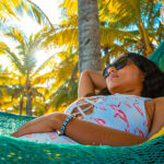 Solo traveler relaxing in a hammock on the beach