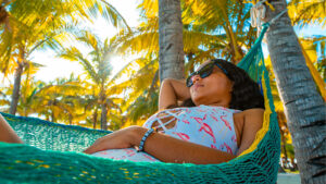 Solo traveler relaxing in a hammock on the beach