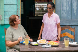women eating East Indian dish in Southern Belize