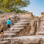 Travelers climbing the temple at Cerros in Corozal District, Belize